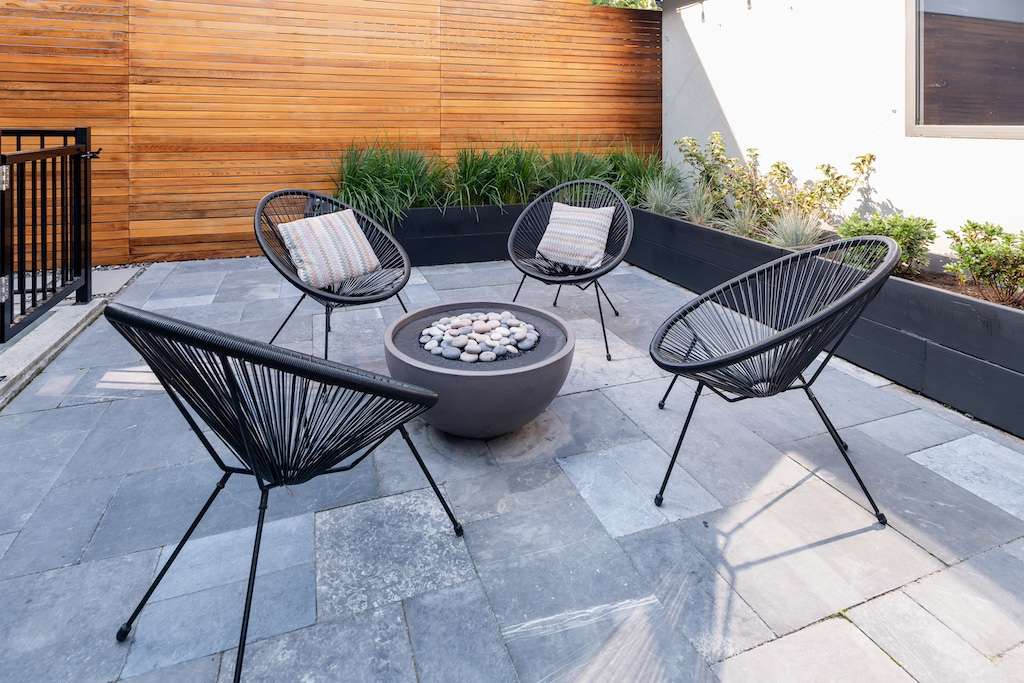 Fire pit with Acapulco chairs by Craine Projects